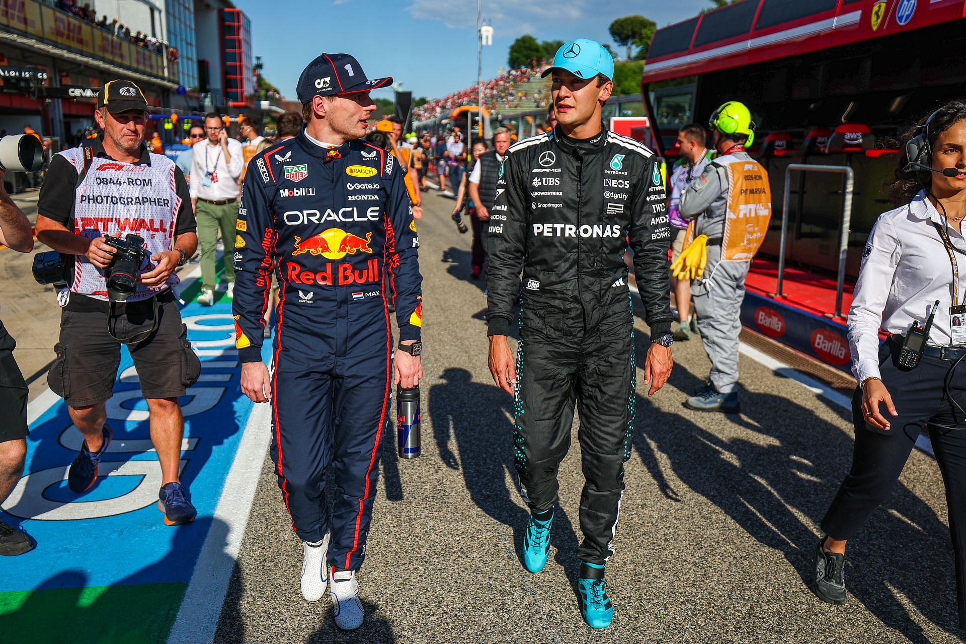 Max Verstappen walks in pit lane with George Russell during Imola qualifying. Source: Getty